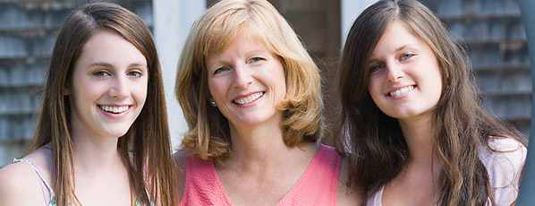 woman and teen girls smiling